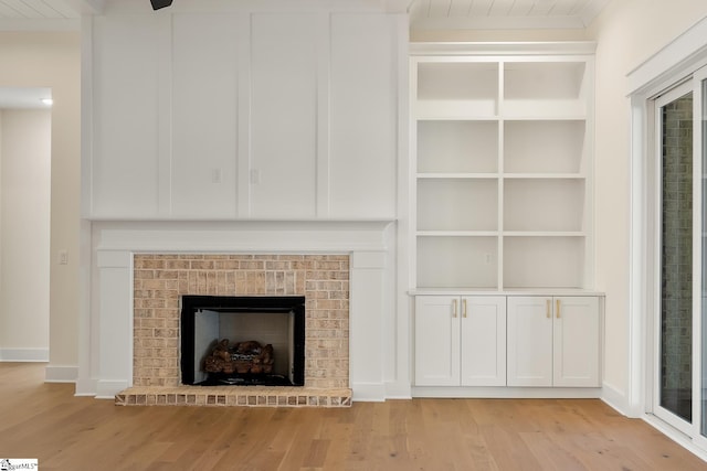 unfurnished living room with a fireplace and light hardwood / wood-style floors