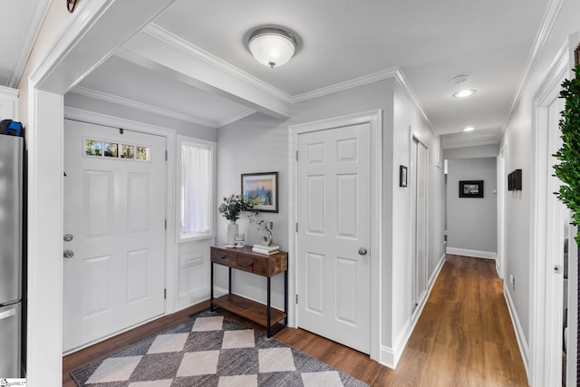 entryway with dark hardwood / wood-style floors and ornamental molding