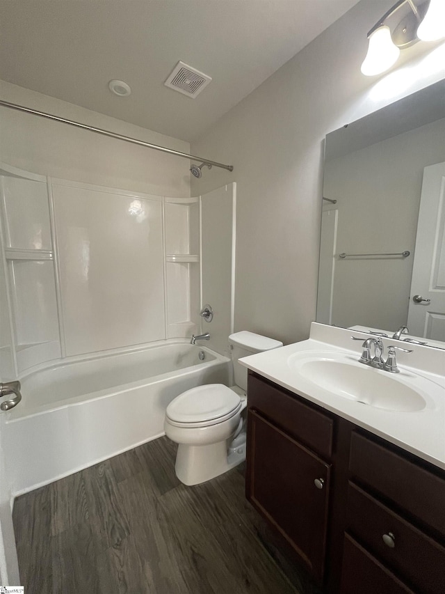 full bathroom with toilet, wood-type flooring, vanity, and shower / bathing tub combination