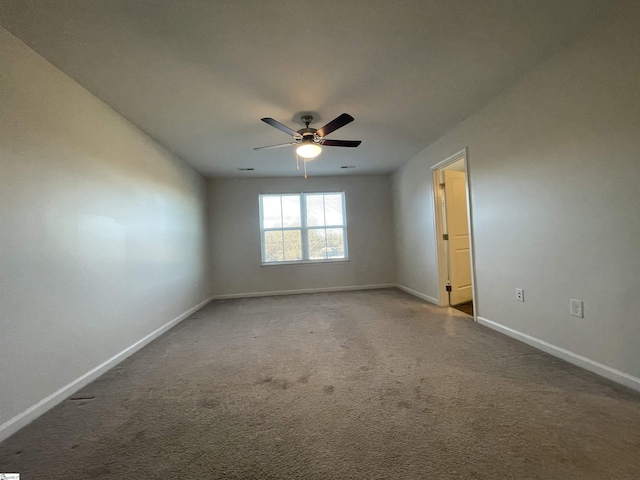 carpeted empty room featuring ceiling fan