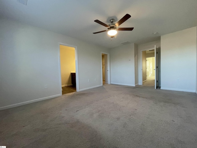 unfurnished bedroom featuring ceiling fan, light colored carpet, and connected bathroom