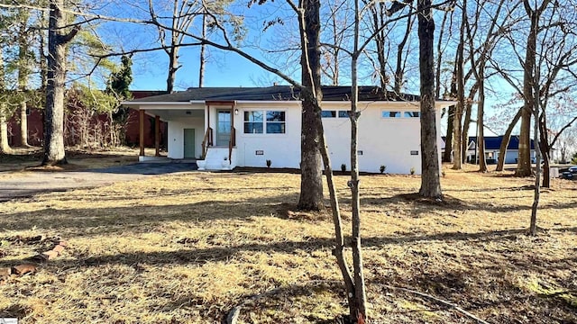 ranch-style home featuring a carport