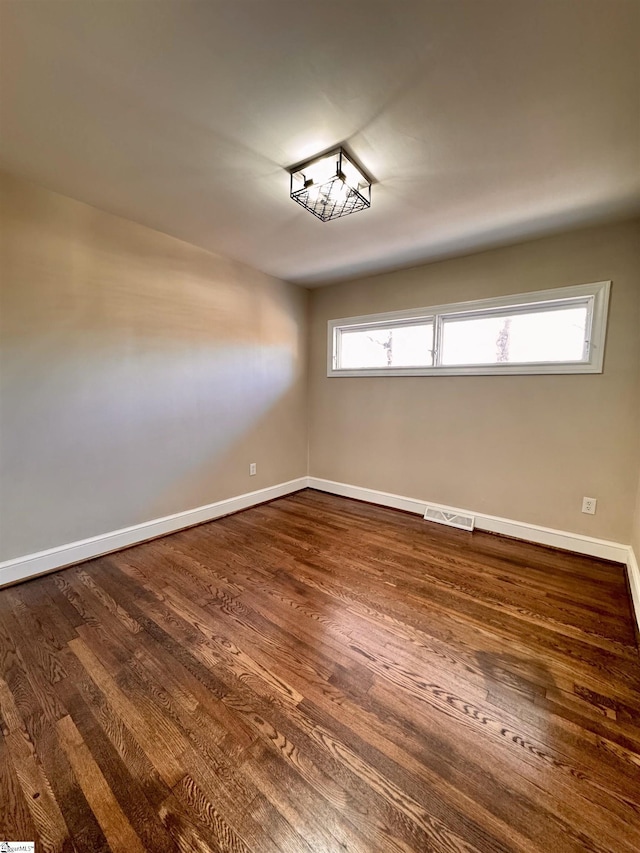 unfurnished room featuring dark hardwood / wood-style floors