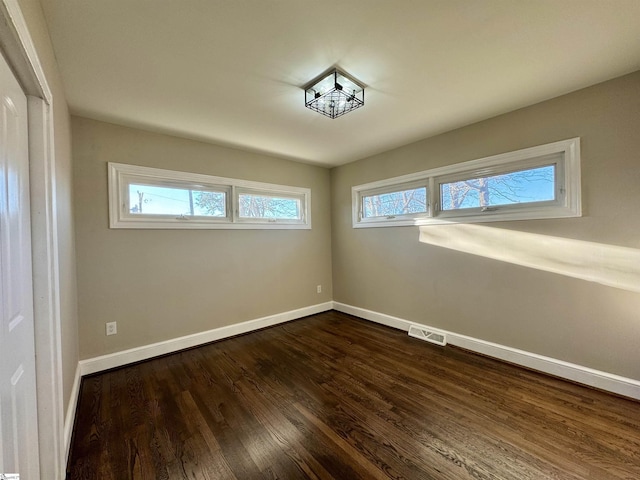 unfurnished room featuring dark hardwood / wood-style flooring