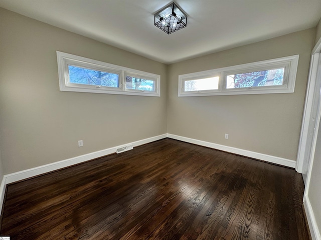 spare room featuring dark hardwood / wood-style flooring