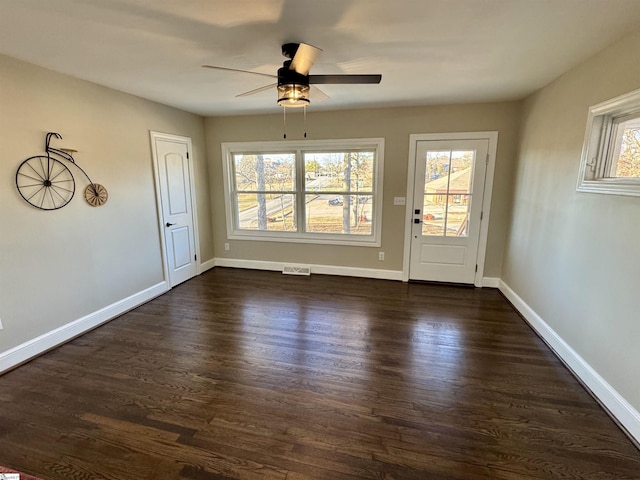 interior space featuring ceiling fan and dark wood-type flooring