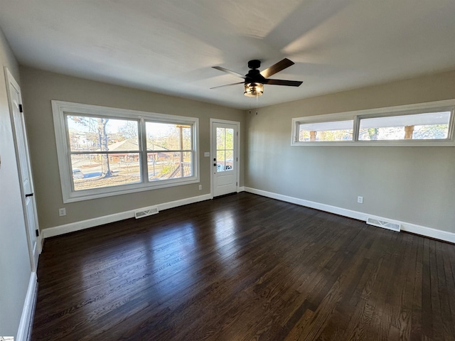 unfurnished room with ceiling fan and dark hardwood / wood-style flooring