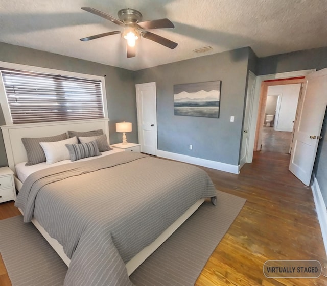 bedroom featuring a textured ceiling, ceiling fan, and hardwood / wood-style floors