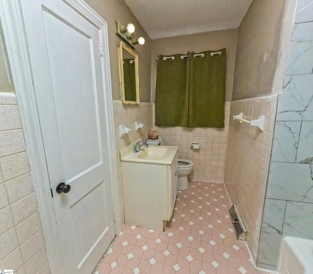 bathroom featuring tile walls, toilet, and vanity