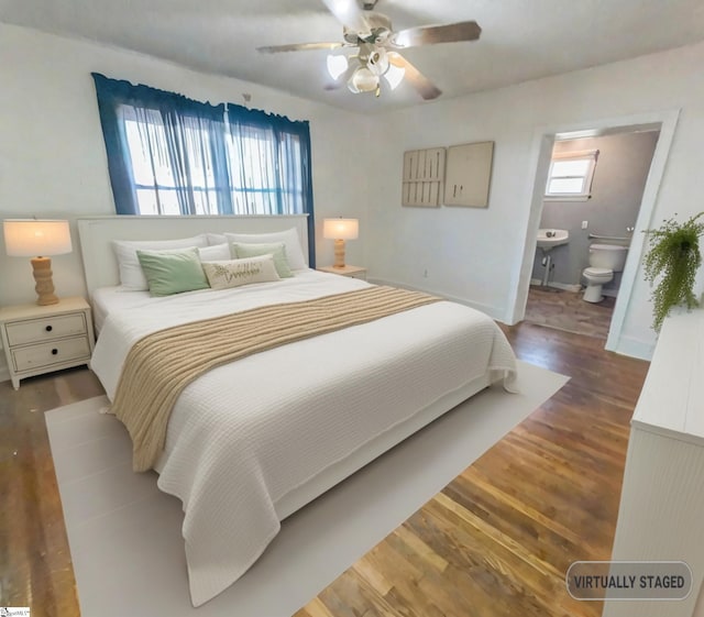 bedroom with ceiling fan, connected bathroom, and hardwood / wood-style floors