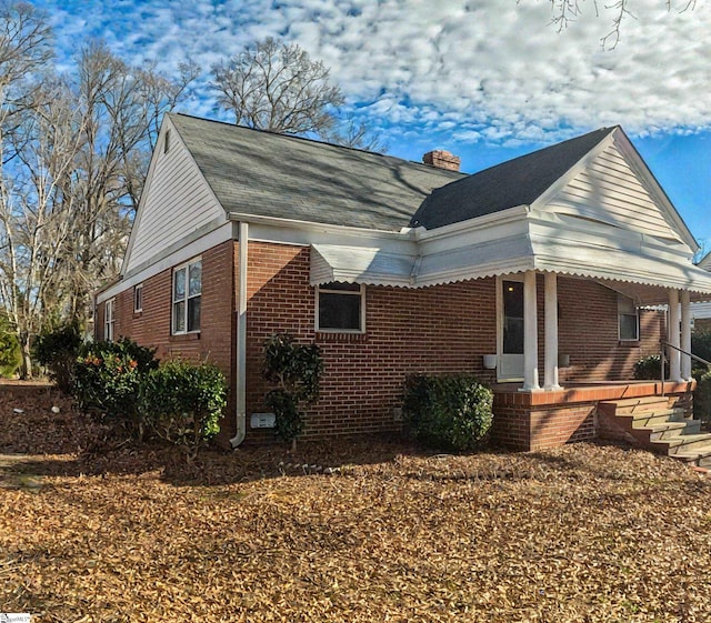 view of property exterior featuring covered porch