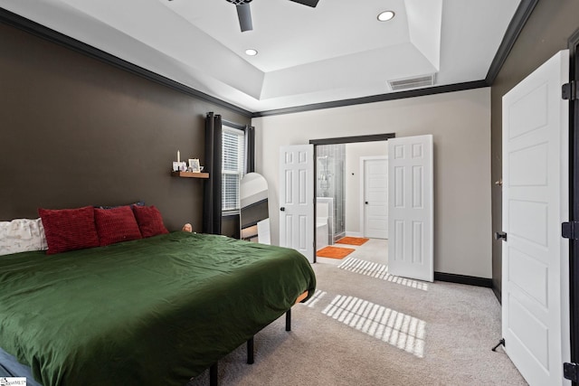 bedroom with light carpet, ceiling fan, connected bathroom, and a raised ceiling