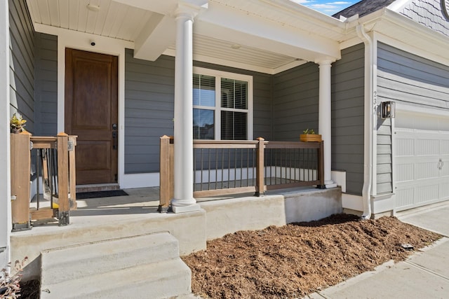 doorway to property featuring a porch and a garage