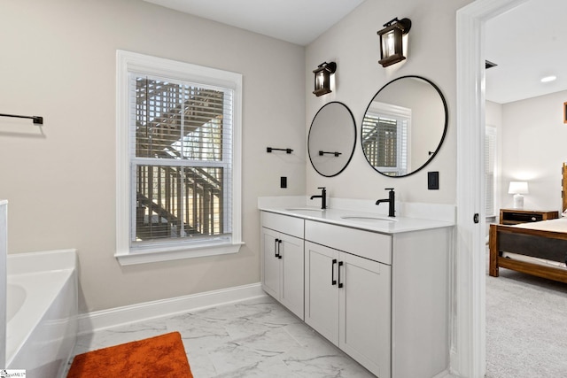 bathroom with vanity and a tub