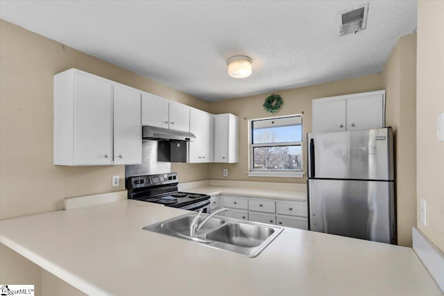 kitchen featuring white cabinets, stainless steel fridge, sink, and range with electric cooktop