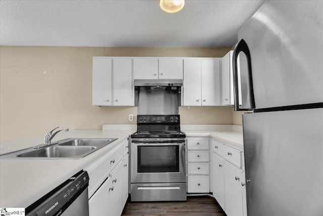 kitchen featuring a textured ceiling, stainless steel appliances, white cabinetry, and sink