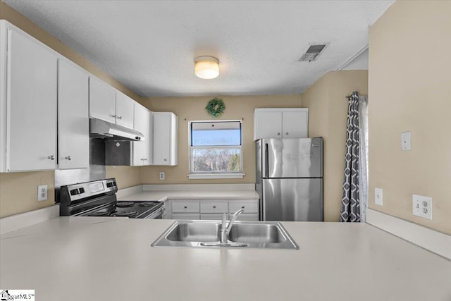 kitchen with sink, white cabinetry, appliances with stainless steel finishes, and a textured ceiling