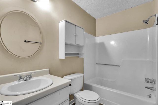 full bathroom featuring toilet, shower / bath combination, vanity, and a textured ceiling