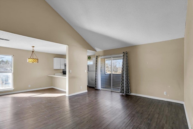 unfurnished living room featuring vaulted ceiling and dark hardwood / wood-style floors