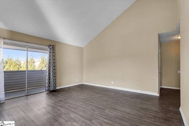 spare room featuring dark hardwood / wood-style floors and high vaulted ceiling