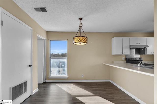 kitchen with a textured ceiling, stainless steel electric stove, white cabinets, and hanging light fixtures