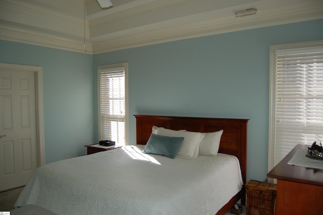 bedroom with ceiling fan and ornamental molding