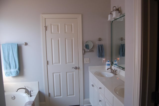 bathroom with vanity and a bath