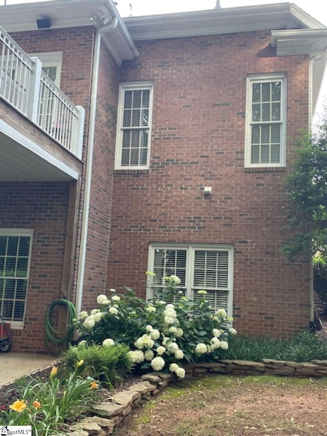 view of side of property featuring a balcony