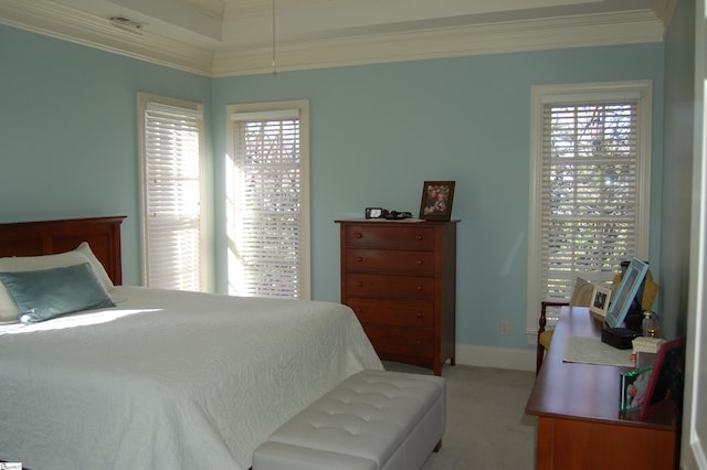 carpeted bedroom with multiple windows and ornamental molding