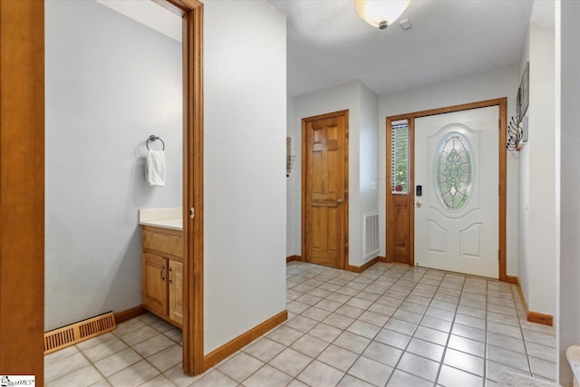 foyer entrance with light tile patterned flooring