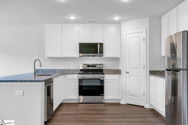 kitchen featuring sink, white cabinetry, kitchen peninsula, and stainless steel appliances