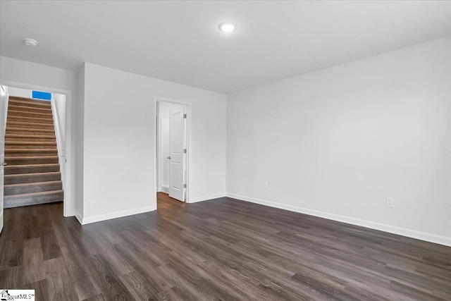 unfurnished room featuring dark wood-type flooring