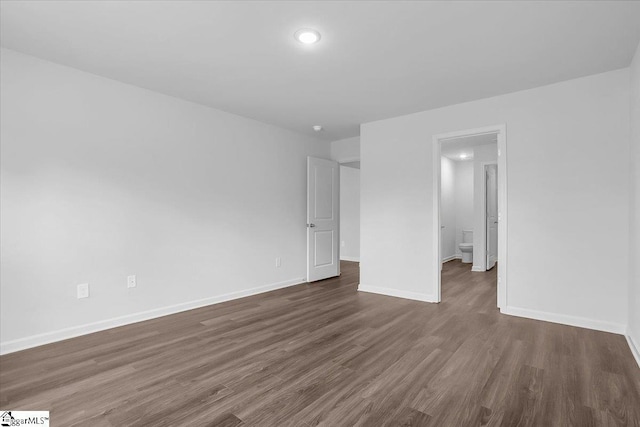 unfurnished bedroom with dark hardwood / wood-style flooring