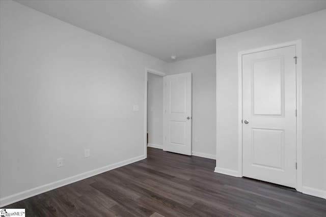 unfurnished bedroom featuring dark hardwood / wood-style flooring