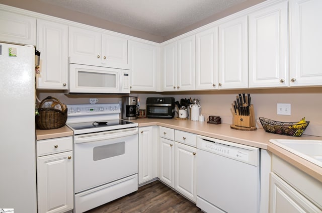 kitchen with white cabinets, dark hardwood / wood-style flooring, white appliances, and a textured ceiling