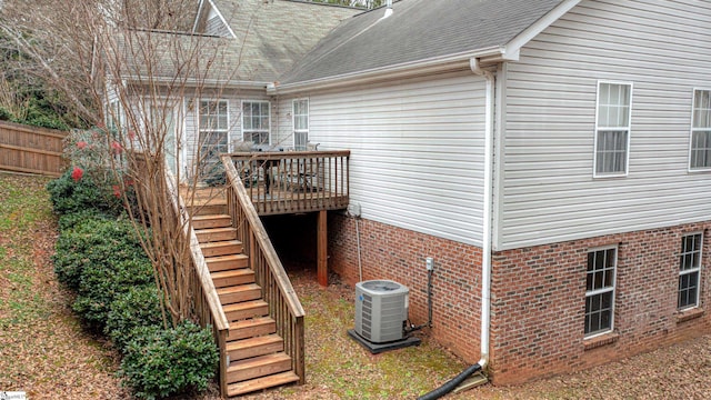 view of property exterior featuring a wooden deck and cooling unit