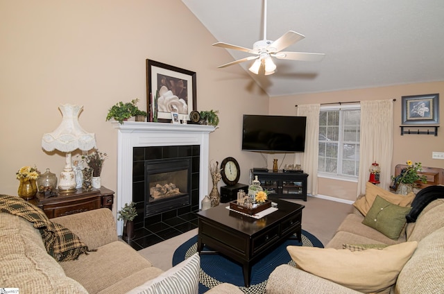 living room featuring ceiling fan, carpet, lofted ceiling, and a tile fireplace