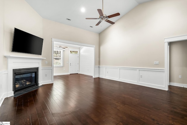 unfurnished living room featuring dark wood-type flooring, ceiling fan, and high vaulted ceiling