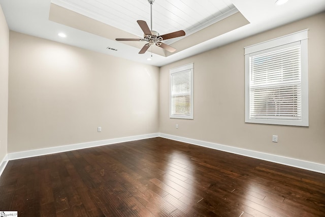 unfurnished room featuring dark wood-type flooring, wooden ceiling, a tray ceiling, and ceiling fan