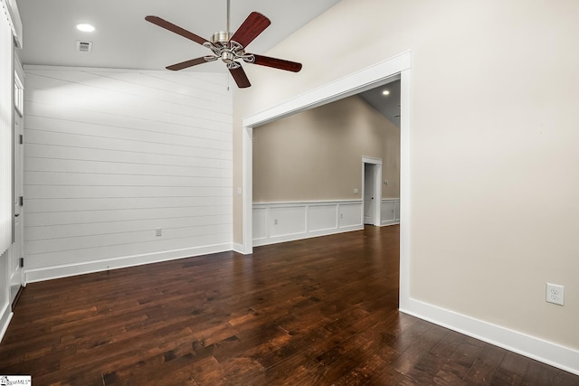 unfurnished room featuring ceiling fan, vaulted ceiling, and dark hardwood / wood-style floors