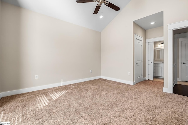 unfurnished bedroom with ceiling fan, lofted ceiling, carpet floors, and ensuite bath