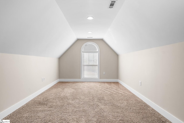 bonus room featuring carpet floors and lofted ceiling