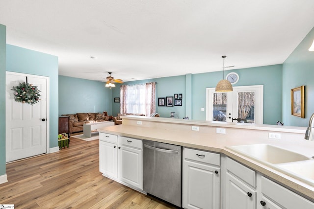 kitchen featuring decorative light fixtures, stainless steel dishwasher, light wood-type flooring, white cabinets, and french doors