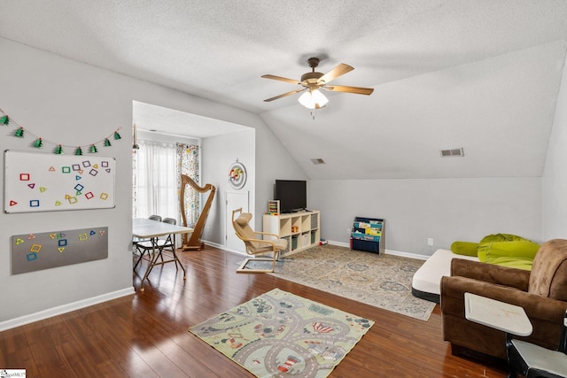 interior space with vaulted ceiling, ceiling fan, dark hardwood / wood-style flooring, and a textured ceiling