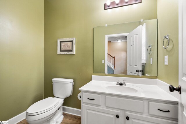 bathroom featuring hardwood / wood-style floors, toilet, and vanity