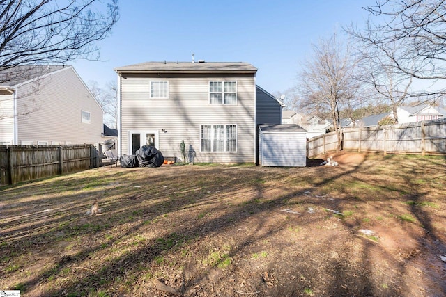 back of property with a yard and a shed