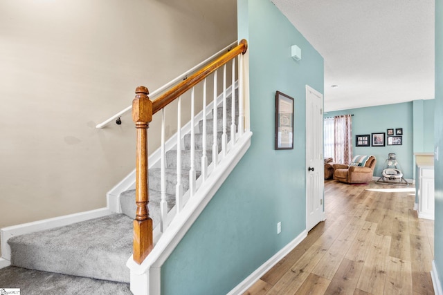 staircase featuring hardwood / wood-style flooring