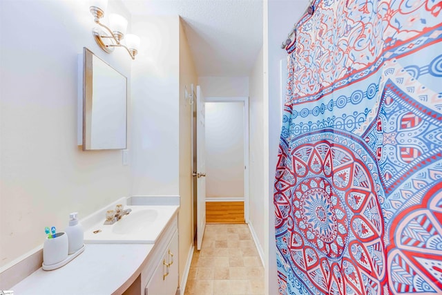 bathroom featuring vanity and a textured ceiling