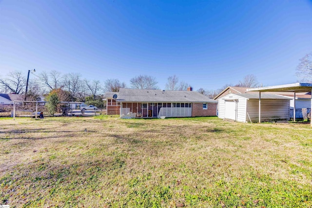 back of property featuring a storage unit and a yard