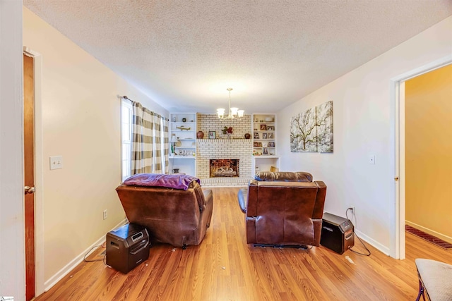 living room with a chandelier, built in features, a textured ceiling, and hardwood / wood-style floors